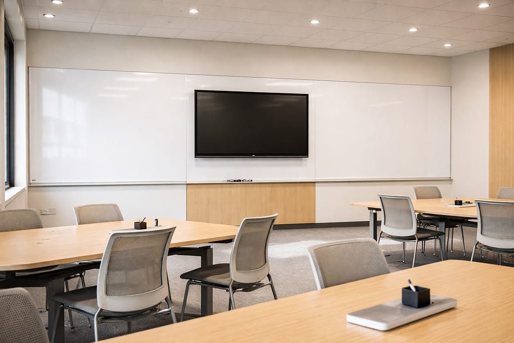 Modern Collaboration Wall with Porcelain Steel Whiteboard Modern classroom with wall-to-wall porcelain steel whiteboard and integrated display
